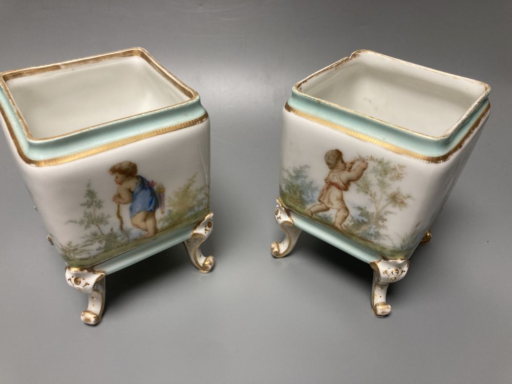 A set of three 19th century French porcelain jardinieres, painted with classical children playing, tallest 14.5cm width 22cm